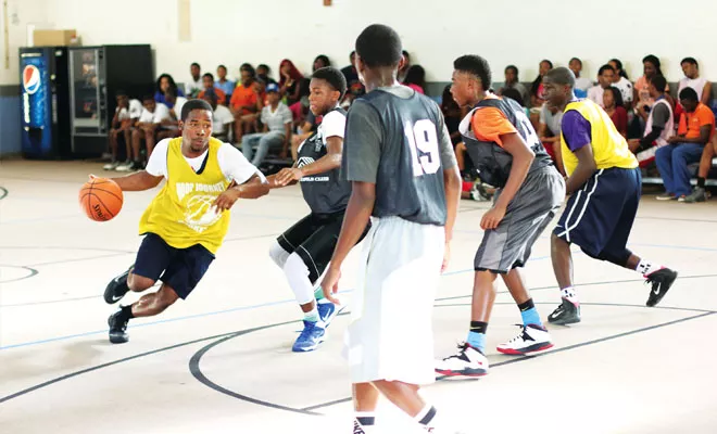 Lanphier senior forward Kalvin Ceasar drives to the hoop against three defenders at the Boys and Girls Club in Springfield. - PHOTO BY PATRICK YEAGLE