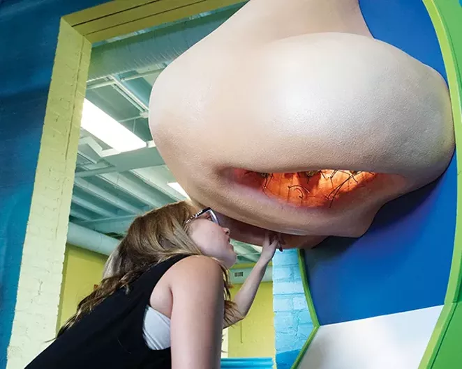 Myla Shannon looking up the Nose Knows exhibit to see what is inside. Little did she know that a snot bubble was about to erupt out of the left nostril! - PHOTO BY LEE MILNER