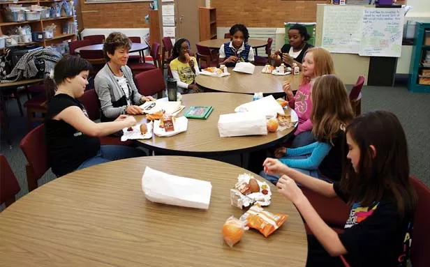 From left, Rachel Knott, volunteer Cindy Murphy from Prairie Center Against Sexual Assault, Terriaunna Brown, Dejuana Cooper, Raynesha Nolden, Brandy Doud, Addison Greff and Kalyn Thomas get together over lunch for a Girl Power Hour. - PHOTO BY DAVID HINE