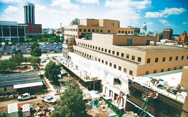 A construction crew works on the exterior of the new surgical wing at St. John’s Hospital. This photo was taken from the eighth floor of the patient tower facing south toward Madison Street. - PHOTO BY PATRICK YEAGLE