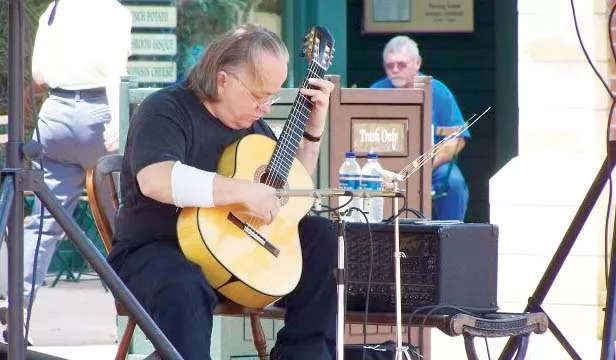 Classical guitarist Russel Brazzel, pictured here performing downtown at an Artist on the Plaza event, will perform at the Springfield Classical Guitar Society on Oct. 16 at 8pm. - PHOTO COURTESY PHOTOS-ETC.BLOGSPOT.COM
