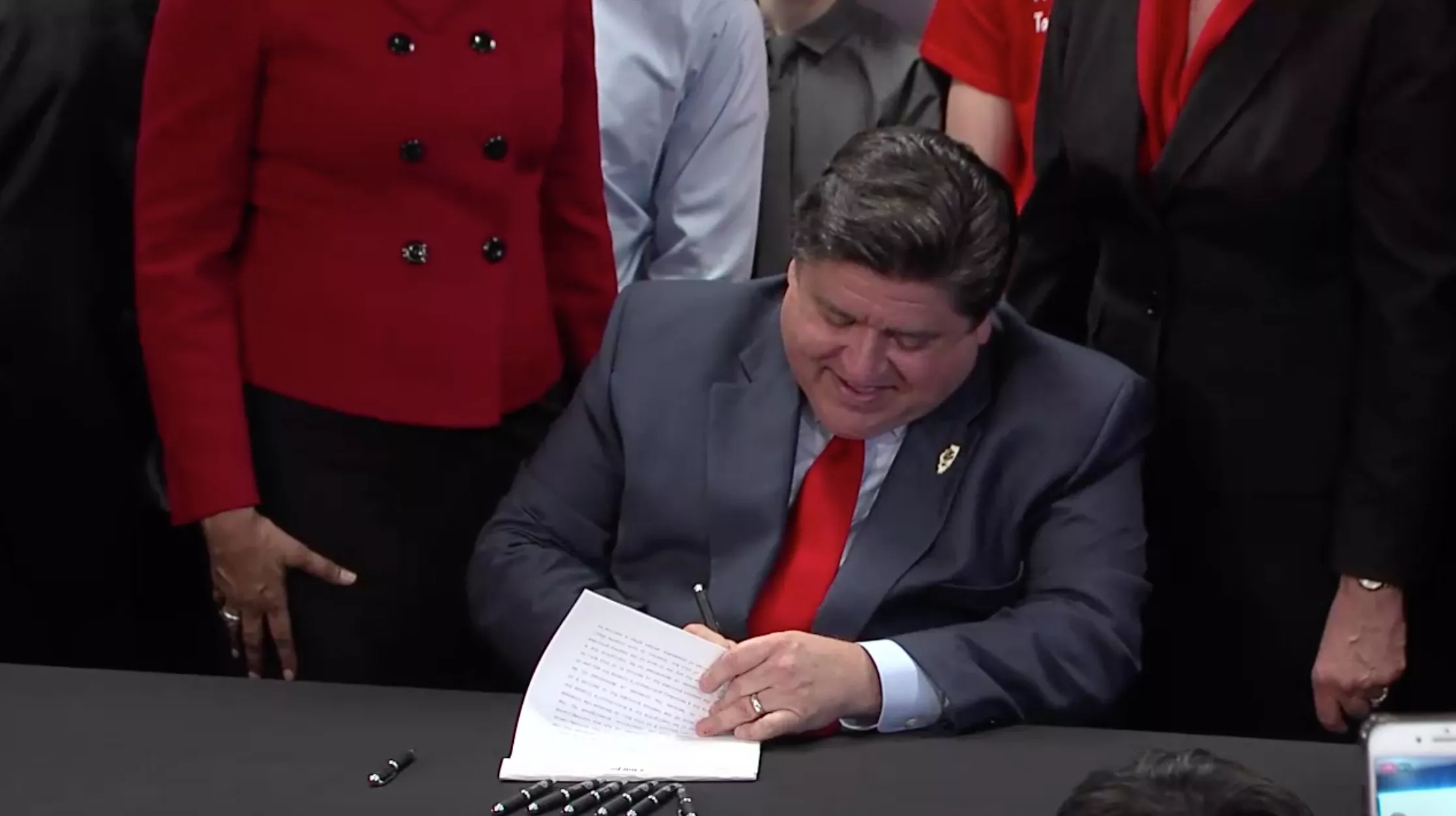 Gov. J.B. Pritzker on April 7 signs into law a bill that raises to 21 the minimum age people can legally buy tobacco products in Illinois. Pritzker signed the legislation at the Mile Square Health Center in Chicago.