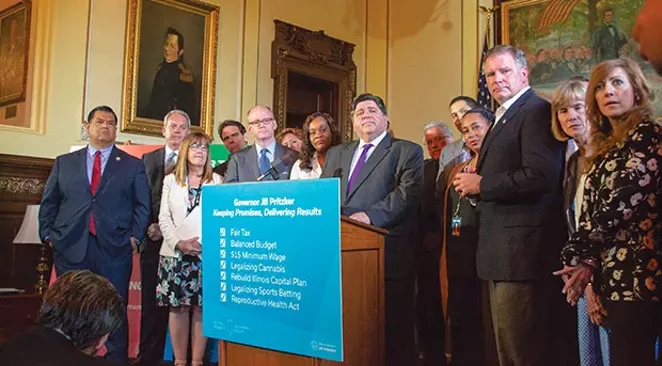 Gov. J.B. Pritzker stands among a bipartisan group of senators in his Capitol office Sunday, June 2, after the Senate gave bipartisan approval to several of his key initiatives to close out the legislative session. - PHOTO CAPITOL NEWS ILLINOIS PHOTO BY JERRY NOWICKI.