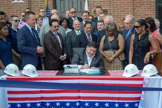 Gov. J.B. Pritzker has signed several bills aside from the more publicized ones he has been promoting, such as the capital infrastructure plan he is pictured signing. - PHOTO BY JERRY NOWICKI