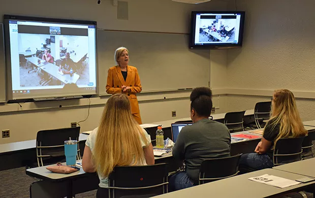 Professor Ronda Mitchell teaches a University of Illinois Springfield class that is creating a pathway for those currently working as para-professionals or classroom aides, or who are a few credits shy of completing a teaching degree. Students from Decatu - PHOTO BY DAVID BLANCHETTE