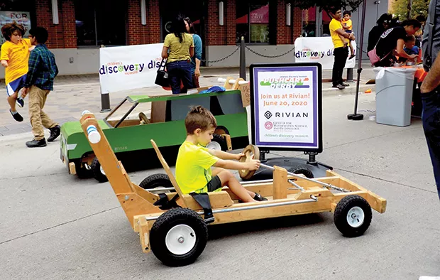 Exaiver Goshorn, 6, prepares for the future on a pushcart, the type built at an annual pushcart derby sponsored by the Children’s Discovery Museum in Normal that Rivian has agreed to host. - PHOTO BY BRUCE RUSHTON