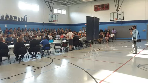 Erica Smith, director of Helping Hands, explained plans for a new homeless shelter to a crowd at the Boys and Girls Club on July 24 that included plenty of upset neighbors. - PHOTO BY BRUCE RUSHTON
