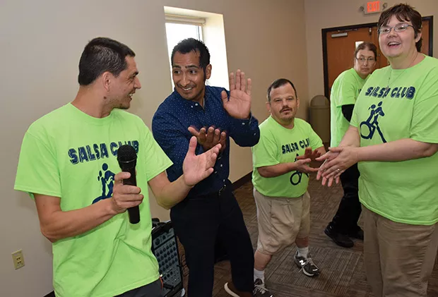 Salsa Club President Jesse Mattern, left, and Barrenzuela lead a session at Pathway Services Unlimited in Jacksonville.