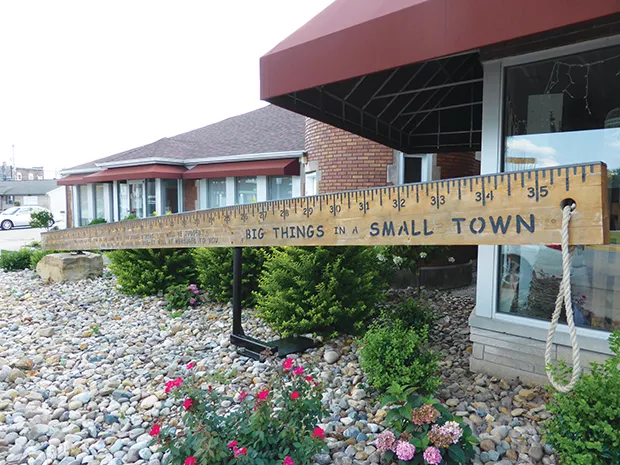 A giant yardstick graces the front yard of an investment planner’s office in Casey, home to multiple large items that serve as tourist attractions for the small town. - PHOTO BY BRENT BOHLEN