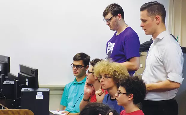 Esports coach Dalton McGhiey, standing in white shirt, oversees tryouts for the Springfield Capitols. - PHOTO BY BRUCE RUSHTON