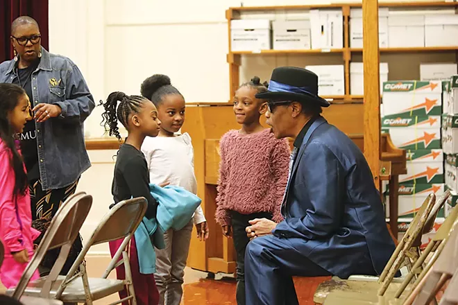 James Armstrong plays and talks music and culture with a group of students at Dubois Elementary School in Springfield. - PHOTO COURTESY MICHAEL GOZA / ILLINOIS CENTRAL BLUES CLUB