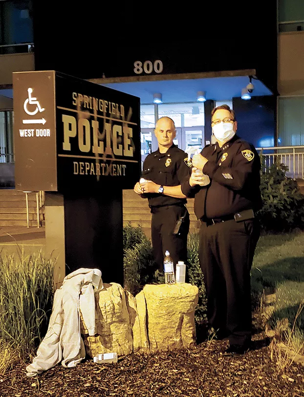 Springfield police chief Kenny WInslow - prepares to scrub graffiti from a sign outside police headquarters on May 31, the same night a police SUV drove over a - loudspeaker belonging to a protester. - The chief says it was inadvertent. - PHOTO BY RACHEL OTWELL