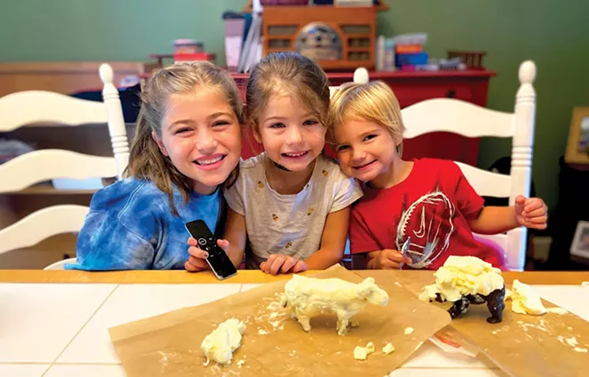 Grace (10), Cecelia (5) and Leo (2) display their finished creations. Bottom: Leo was excited to try his hand at sculpting with butter. - PHOTOS BY LANA SHOVLIN