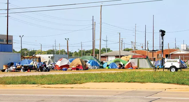 Approximately 50 homeless people have created Tent City behind the City of Springfield’s Warming/Cooling Center at 1015 E. Madison St. Volunteers come every day to provide meals and supplies. - PHOTO BY BRANDON TURLEY