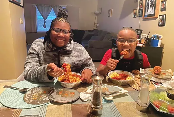 Club Compass participants Annise and Issaac enjoying their spaghetti and meatballs from Copper Pot Cooking Studio as part of Meals that Matter on Jan. 27. - PHOTO COURTESY COMPASS FOR KIDS