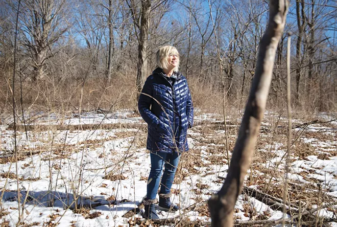 Susan Helm at Lincoln Memorial Garden, a place she loves. Susan served on the board for two terms and founded the 8K trail run which she directed six times. She also helps with the garden’s native plant sales, leads nature hikes and has a good time flipping pancakes at the annual pancake breakfast fundraiser. - PHOTO BY RICH SAAL