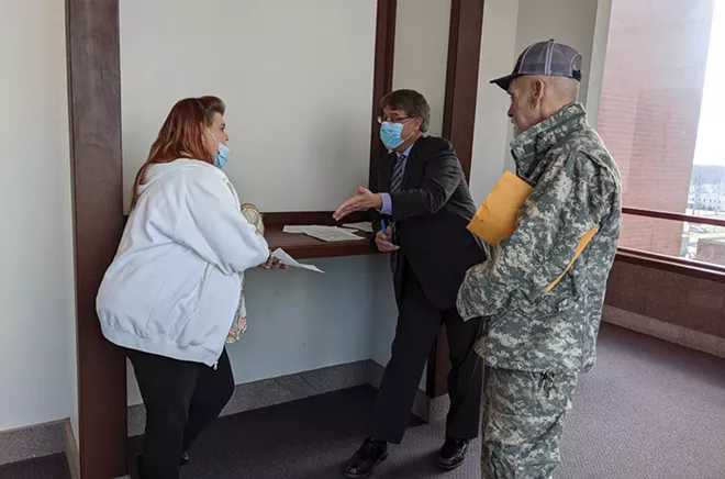Fred and Korie Brandt make a deal with Michael Durr, lawyer for a landlord seeking eviction. - PHOTOS BY BRUCE RUSHTON