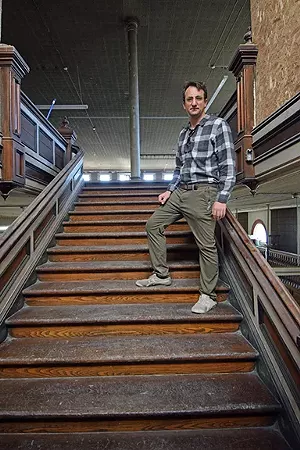 Douglas Pope on the staircase leading to the Broadgauge's second floor ballroom. - PHOTO BY DAVID BLANCHETTE