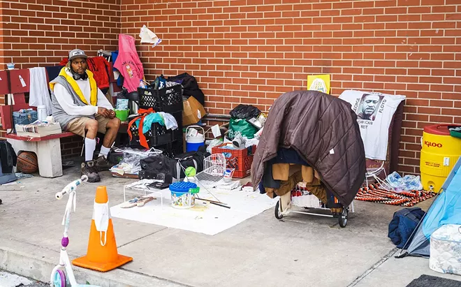 A photo taken in early July of a resident of the tent city that surrounds the former Salvation Army building at 221 N. 11th Street. Planners have proposed the building be used as an overflow shelter. For now, no one is allowed to stay in it overnight. - PHOTO BY ZACH ADAMS, 1221 PHOTOGRAPHY