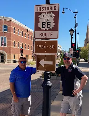 Greg "Coop" Cooper (left) and Shane "Shaner" McDermith take a stand by a Route 66 designation sign near Sixth and Capitol. - PHOTO BY TOM IRWIN