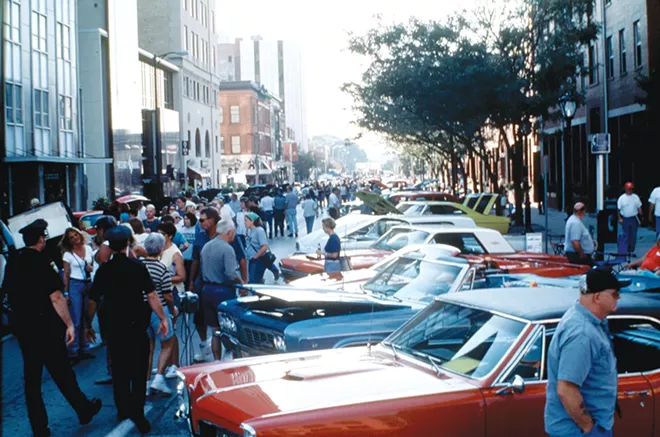 Cars and spectators fill Monroe Street from an early show. Notice the pay phone in the right side of the photo.