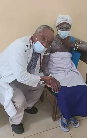 Dr. Agamah and his patient. Her skin paint reflects her participation in voodoo medicine in her village. - PHOTO BY DR. MICHAEL FENNER