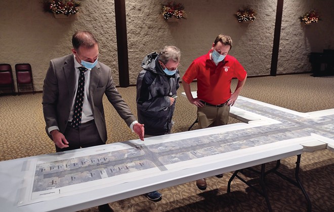 Springfield Public Works Director Nate Bottom (left) and Fuhrmann Engineering project engineer Matt Smith (right) speak with resident Jim Dickey about diagrams outlining proposed changes along MacArthur Boulevard at an open house meeting at Westminster Presbyterian Church Dec. 6. - PHOTO BY KENNETH LOWE