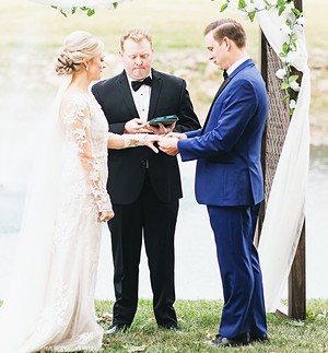 Hannah and Austin Mudd were wed under an arbor that Austin made. Hannah’s brother, Mitch Koehler, served as the officiant - .  PHOTO BY JILL GUM PHOTOGRAPHY