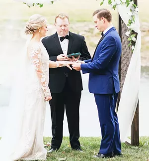 Hannah and Austin Mudd were wed under an arbor that Austin made. Hannah’s brother, Mitch Koehler, served as the officiant - . PHOTO BY JILL GUM PHOTOGRAPHY