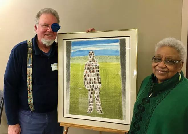 Mike Lang and Dolores Martin with “The Oneness of Mankind,” a piece by the late Jim Johnston, a longtime member of the Springfield Baha'i community. - PHOTO BY ROGER LUTLEY.