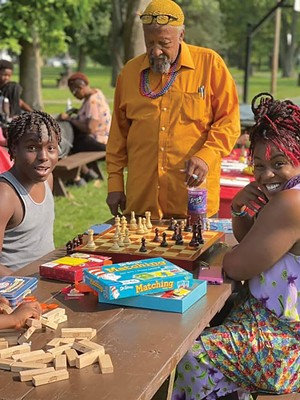John T. Crisp, Jr., co-founder of the Garvey-Tubman Center, and Shatriya Smith, executive director, teach chess to a student in the Better Life for Better Living program.