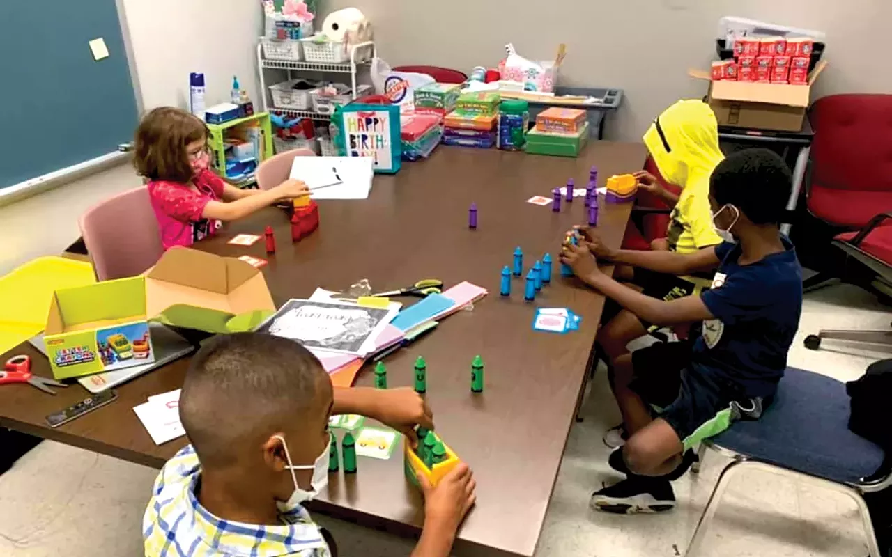 Second-graders at Camp Compass at Wilcox Elementary use letters to make words that match pictures. The summer programming has a focus on fun and play that leads to learning.