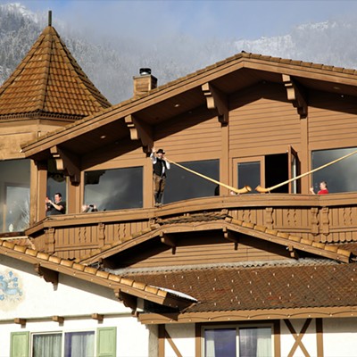 The sun breaks through Saturday morning after days of rain and snow to brilliantly illuminate two alpine horn players atop the restaurant balcony of the Enzian Inn in the Bavarian styled village of Leavenworth, Washington. The picture was taken by Keith Collins on February 8, 2020.