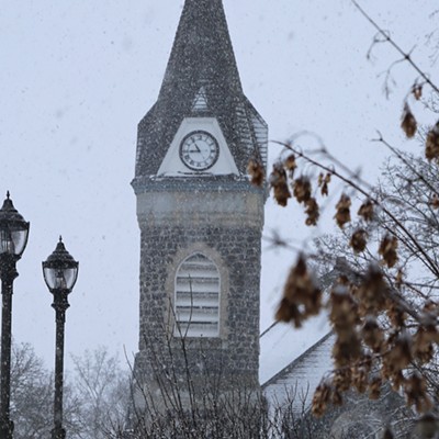 The Moscow First United Methodist clock tower in a snow squall on Friday morning, February 26, 2021, with the unique lamp posts of the 1912 Center in the foreground. Later in the morning this scene was bathed in sunshine.