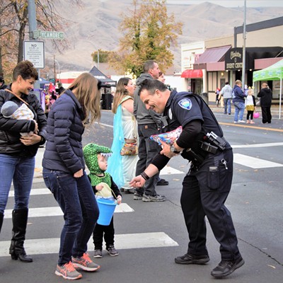 Officer Morbeck of the Clarkston Police, seemed to really enjoy handing out candy to the many ghosts and goblins that passed by. Taken October 31, 2018 by Mary Hayward.