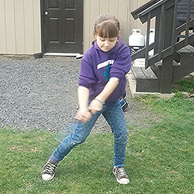 Emma Hemphill, 7, of Lewiston, takes a swing at golf ball Sunday, March 22, at her home in the Lewiston Orchards. Emma's parents are&nbsp;Matt and Jeanette Hemphill. Photo by grandfather Dan Aeling of Lewiston
