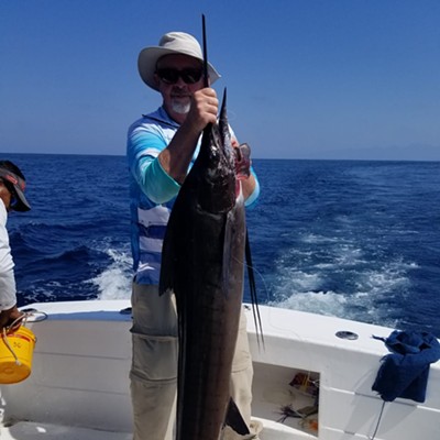 Bruce Howard holding up a 50 pound Marlin he caught while out with his friends on March 11, 2024.