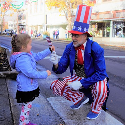 Our Granddaughter, Lila, receiving a flag to wave for the Veterans Day Parade, Nov. 11, 2017. Photo taken by Mary Hayward of Clarkston.