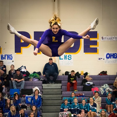 Sydnee Soderberg, of the LHS Bengal cheer squad, is thrown high into the air during coed group stunt competition. Photo was taken on February 27th, 2016 at Booth Hall during district state qualifier. Photo courtesy of Max Moore.