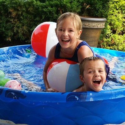 Our Grandchildren Alisha and Adam in our kiddy pool July 2015 Photographer Mary Hayward of Clarkston