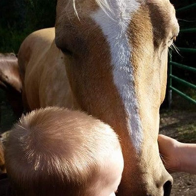 McKenzie's son giving his horse a goodbye kiss