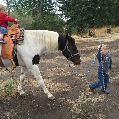 Grasyn Beloit giving his little brother Bentley a ride