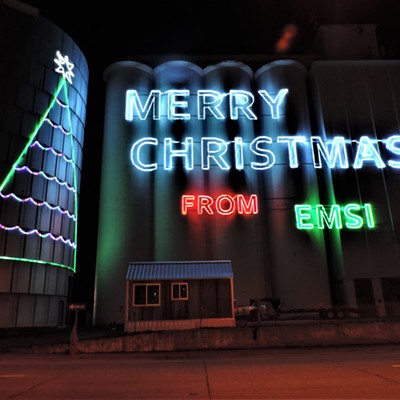 A Merry Christmas message from Emsi is on the old Latah County Grain Grower buildings in Moscow on the night of 12-2-20. Photo by Keith Gunther