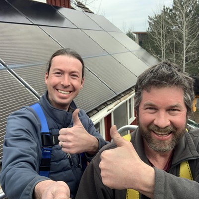Brian Ogle and Garrett Clevenger of SkyGlow Solar give a thumbs up after adding 5 new panels to the Petersen barn's existing solar array.