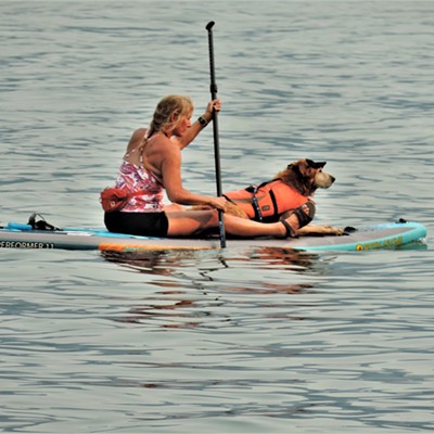 A paddle boarder with a companion ply the waters of Priest Lake, Idaho on July 31, 2021