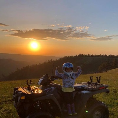 Ava Guel, 5, from Pomeroy, Washington, takes a minute to show her step-dad Lester Geiger, 35, from Cheney, Washington, her muscles on a sunset ride in the Blue Mountains in Pomeroy on May 25, 2018.
    
    Photo by: Lester Geiger, Cheney Wa.
    Mom: Sarah Herres, Pomeroy Wa.