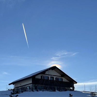 Surprise - it's not a shooting star!  Just before the sunset, our chalet style home was framed with light and blue sky on January 27, 2022. As I readied my camera, the contrail that made me think of fireworks appeared. 

We are east of Mosow looking south.