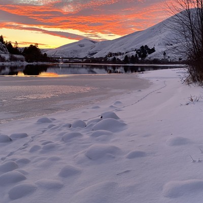 The partially frozen Clearwater River at sunset, as seen from the beach at Falling Feather Farm.