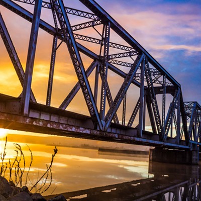 I decided to beat the sunrise a few mornings ago, and opted for a new location. I made my way around the old railway bridge, and scrambled down to the river.
    Waiting for the sunrise, I watched the fog waft past, birds fly to and fro while going about their business, while the sunlight peaked over the distant mountains to play an amazing light show off of the clouds and the fog, all reflected in the tranquil waters.