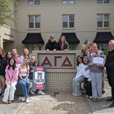 Alpha Gamma Delta residents rally for the chapter's recognition as Sorority Yard of the Semester on April 21. Pullman Mayor Francis Benjamin presents the award certificate to Philanthropy Chair Camden Anderson, while House Director Monica Anderson and College Hill Association Co-Chair Allison Munch-Rotolo look on from behind the sign. Ms. Anderson oversees maintenance of the property at 900 NE B Street in Pullman and says it is the "Best job ever!"